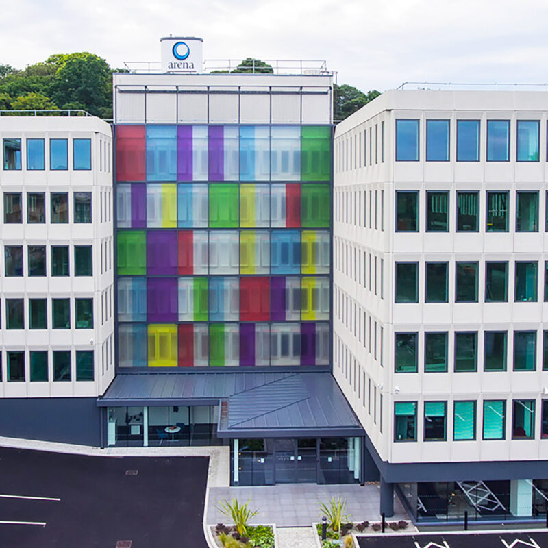 An aerial view of an office building with a coloured-glass exterior design.